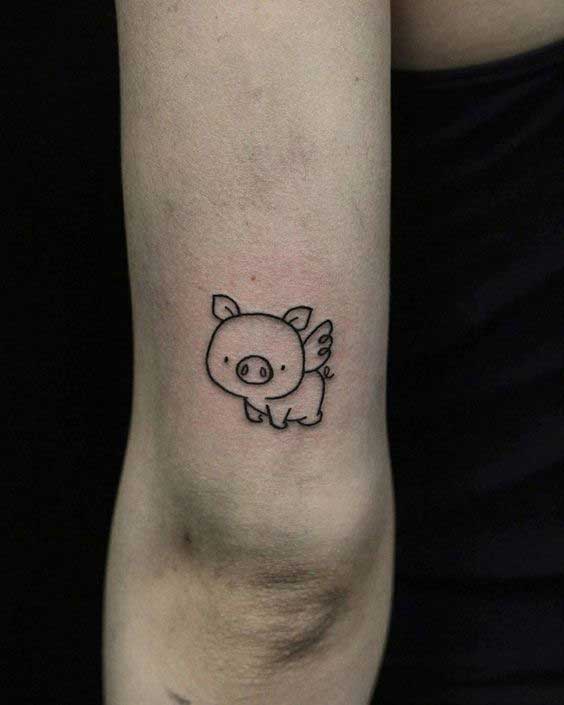 Small pig tattoo on the right inner ankle