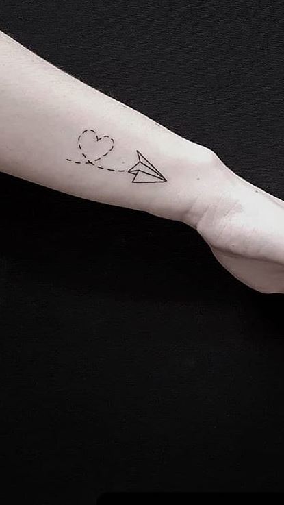 Airplane tattoo located on the wrist minimalistic