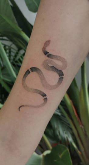 Minimalist black snake tattoo on the sternum  Minimalist tattoo Tattoos  for women Discreet tattoos