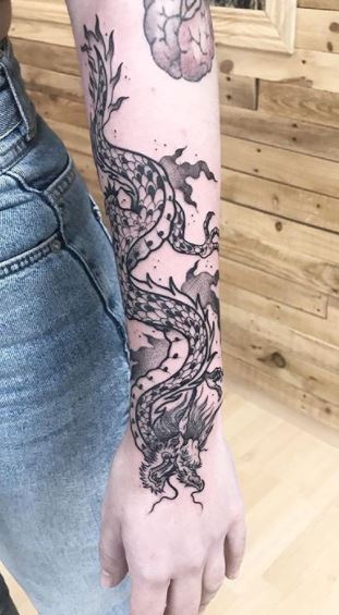 Huge dragon tattoo done on the arm