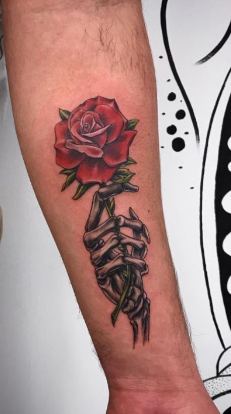 Tattoo uploaded by heartbreak kid  Skeleton hand holdjng rose  Tattoodo